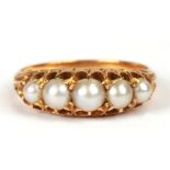 An 18ct gold split pearl ring set with five graduated pearls, approx UK size 'M', 3.4g.Condition