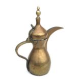 A large Turkish / Islamic brass dallah coffee pot, 41cms high.