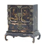 A Japanese lacquer table cabinet, the pair of doors enclosing six short drawers with a long drawer