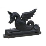 An 18th / 19th century carved wooden figure in the form of a stylised winged dragon, 43cms long.