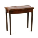 A figured mahogany serpentine tea table on square chamfered legs, 74cms wide.