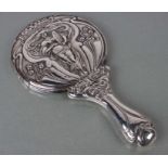 An Edwardian Art Nouveau silver dressing table hand mirror with repousse decoration, Walker &