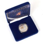 A Millennium silver proof £5 coin, cased, with certificate.