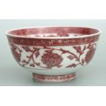 A Chinese underglaze red footed bowl decorated with scrolling flowers, 21cms diameter.