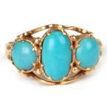 A 19th century yellow metal ring set with three turquoise cabochons, approx UK size 'I', 2g.