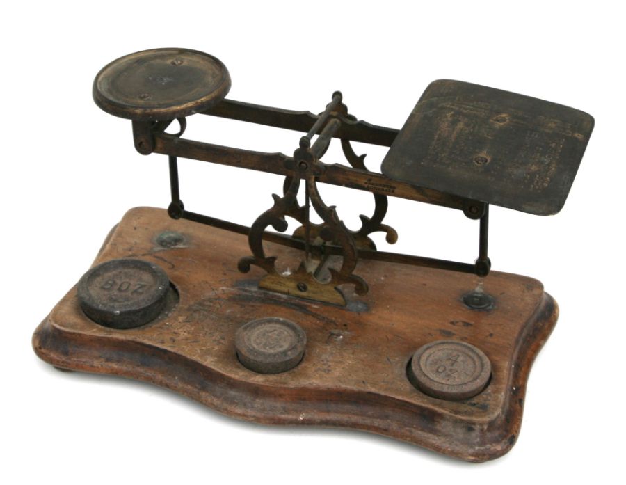 A set of Victorian brass and mahogany postal scales with associated weights, 30cms wide.