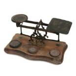 A set of Victorian brass and mahogany postal scales with associated weights, 30cms wide.