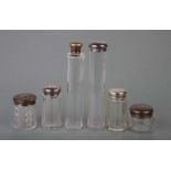 Six Victorian silver topped glass cosmetic jars, various dates and makers (6).