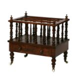 A Victorian walnut three-division Canterbury with single frieze drawer, on turned legs, 54cms wide.