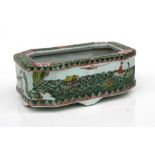 A Chinese famille vert planter of rectangular form decorated with figures within a landscape,