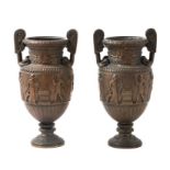 A pair of classical style bronze urns decorated with Grecian figures, 21cms high (2).Condition