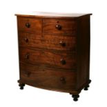 A Victorian mahogany bowfront chest of two short and three graduated long drawers, on turned legs,