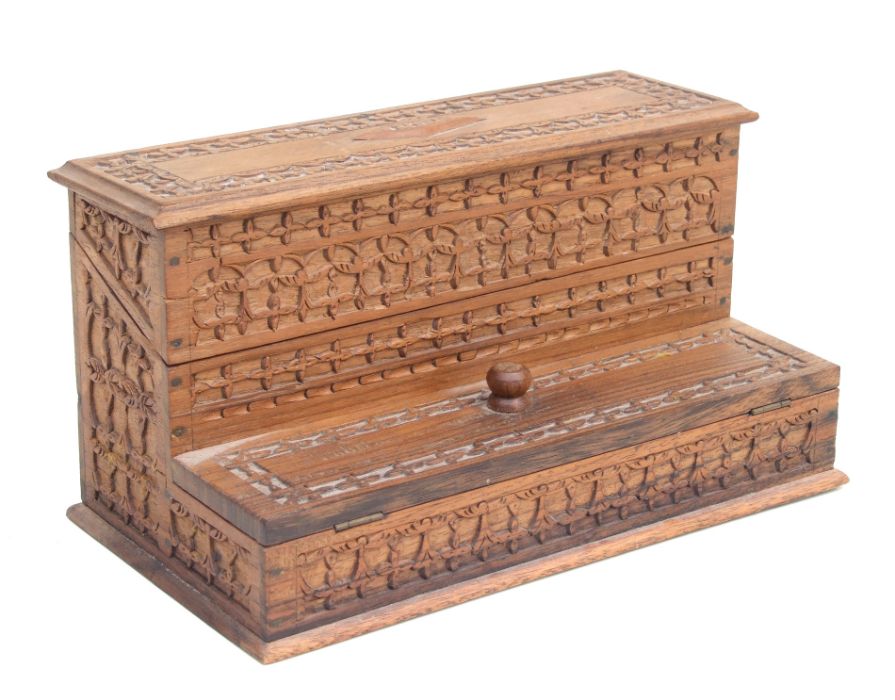 A carved hardwood table top stamp box, 25cms wide.