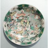 A Chinese famille verte shallow dish decorated with warriors, six character blue mark to the