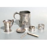 A silver christening mug, a mother of pearl and silver fruit knife; two silver napkin rings, a pin