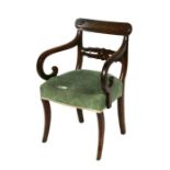 A Regency mahogany elbow chair with upholstered seat, on sabre front supports.