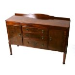 A Waring & Gillow mahogany sideboard with three long drawers flanked by cupboards, on square