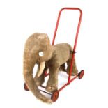 A vintage plush Merrythought push-along elephant, 46cms long.