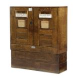 A George V oak double mailbox C.1930, the front with a pair of doors with hinged apertures, with