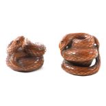 A pair of Japanese carved wooden netsukes in the form of coiled snakes, 3.5cms high (2).