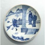 A Chinese blue & white shallow dish decorated with figures on a landscape, 20cms diameter.