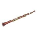 A late 19th / early 20th century hardwood three-piece oboe, 56cms long.