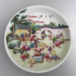 A Chinese Republic style famille rose shallow dish decorated with boys playing in a garden, four