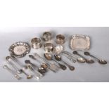 Two silver pin dishes; together with four silver napkin rings, silver sugar tongs, teaspoons and