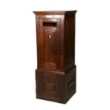 An early 20th century oak country house private posting box with hinged panelled door and single