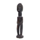 An African carved hardwood tribal figure, 32cms high.
