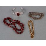 A quantity of costume jewellery to include a rolled gold padlock bracelet, a cherry amber bead