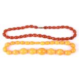A graduated amber type bead necklace; together with another bead necklace (2).