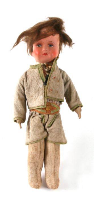 A vintage doll with felt clothing and composite head, 31cms high.