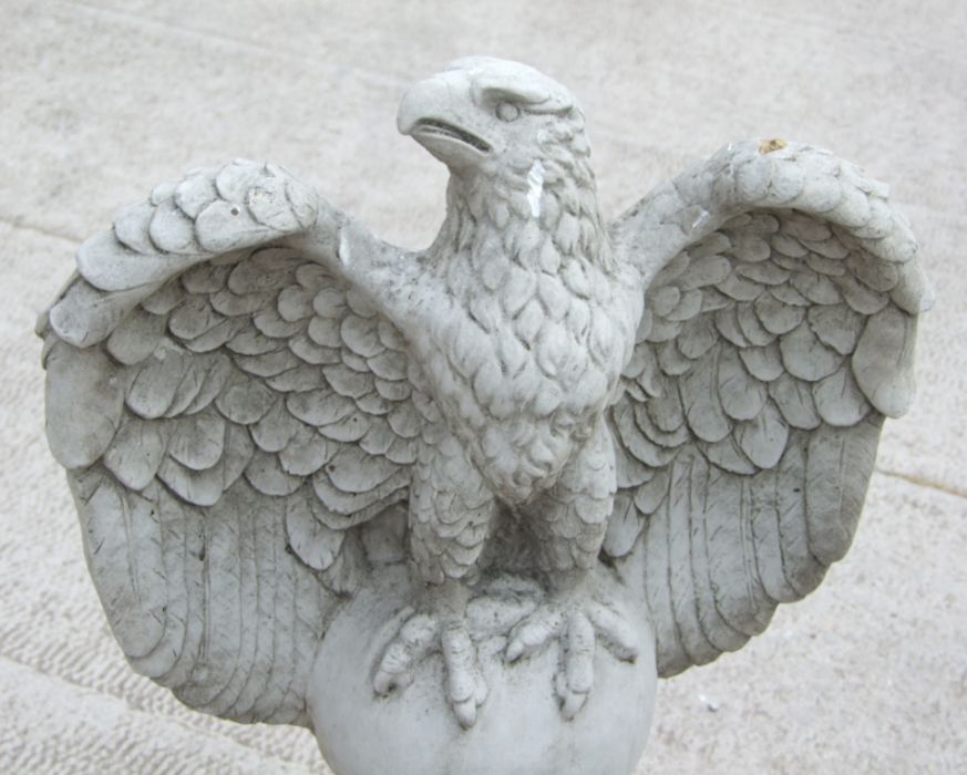 A large pair of stoneware garden eagles perched on a sphere with their wings outswept, 97cms high ( - Image 2 of 5