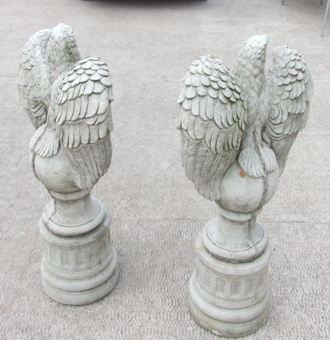 A large pair of stoneware garden eagles perched on a sphere with their wings outswept, 97cms high ( - Image 4 of 5