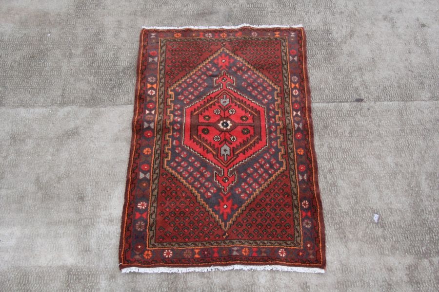 A Persian Hamadan woollen hand knotted rug with central gul within borders, 96 by 140cms (37.5 by - Image 2 of 2
