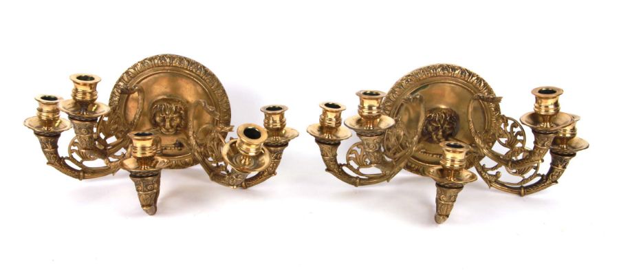 A pair of five-branch bronze wall sconces with lion masks and stylised birds, 36cms wide (2).