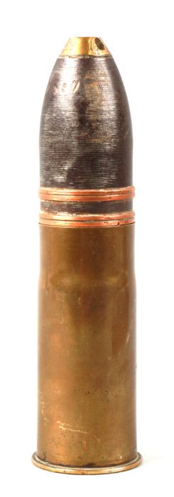 A complete inert WWI artillery shell and brass casing in three parts. Date stamp to the base for