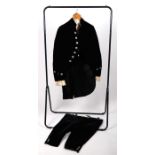 An early 19th century footman's livery comprising a velvet and silk three-piece suit of breeches,