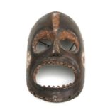 African Art / Tribal Art: A Large African mask, ovoid eyes and mouth with carved teeth. 36cm high