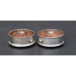 A pair of George III style silver and mahogany wine coasters, 9cms diameter (2).