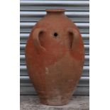 A two-handled terracotta olive jar with banded decoration, of tapering cylindrical form, 71cms high.