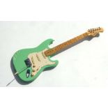 A 1970's Rockburn Electric guitar in spearmint green, 100cms long.
