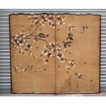 An early 20th century Japanese four-fold screen decorated with birds amongst flowering foliage,