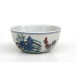 A Chinese doucai tea bowl, decorated flowers and chickens with a six character blue mark to the