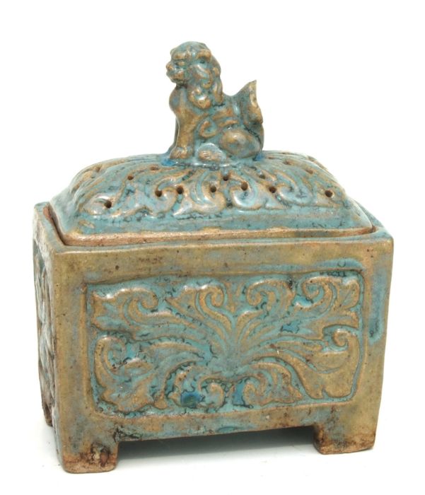 A Chinese celadon glazed incense burner, the cover with a dog of fo, 16cms wide.