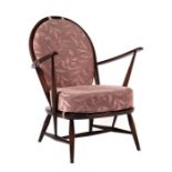 An Ercol mid century dark elm Fleur de Lys easy chair with pierced back splat.