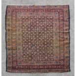 A Persian Hamadan rug with repeated floral design on a blue ground within a multi border, 183 by