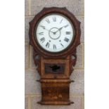 A late Victorian drop-dial wall clock, the white circular dial with Roman numerals, fitted with an