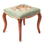 A late Victorian stool with needlework panel seat and cabriole legs, 45cms wide.